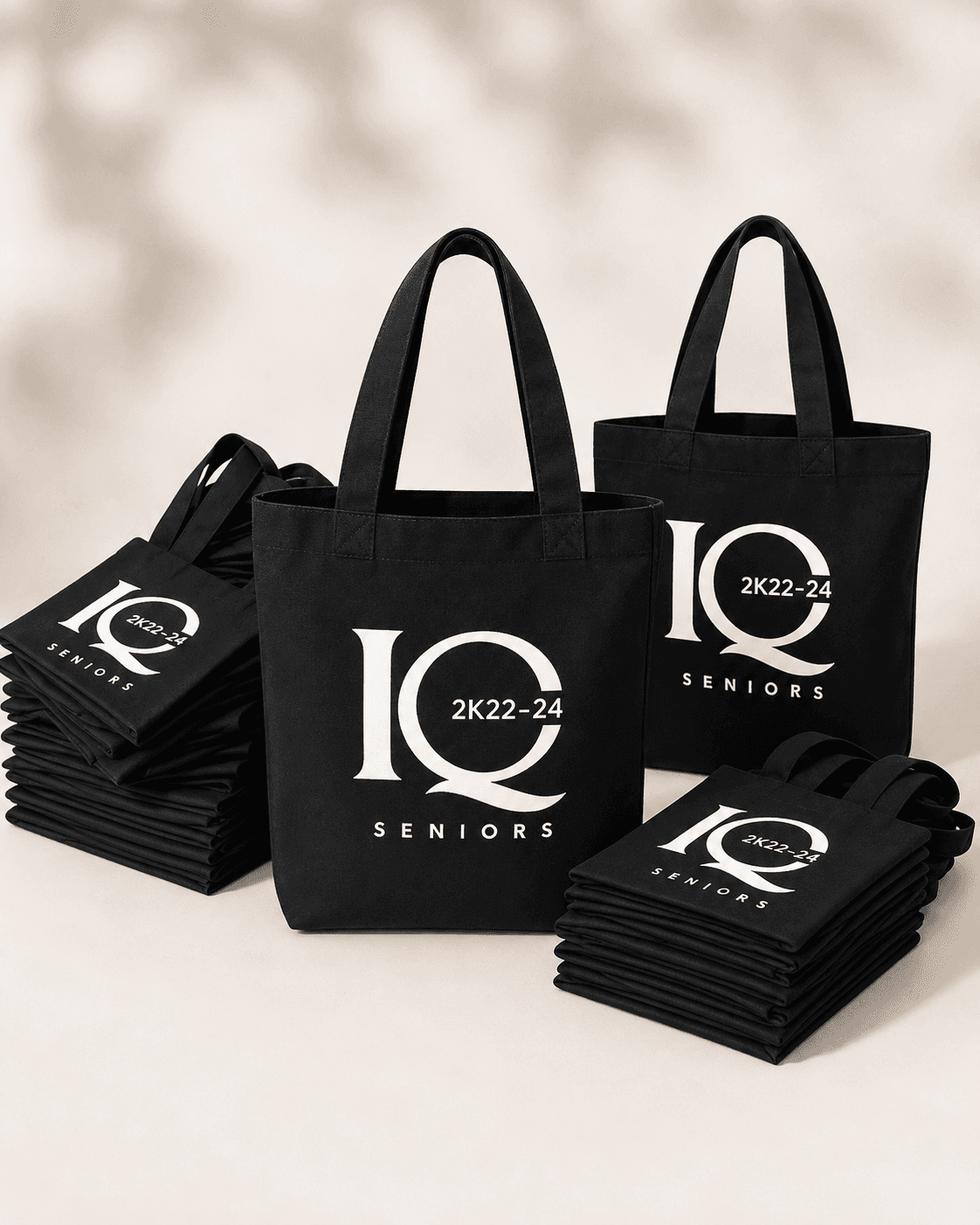 Stack of black branded tote bags printed with a bulk order's logo